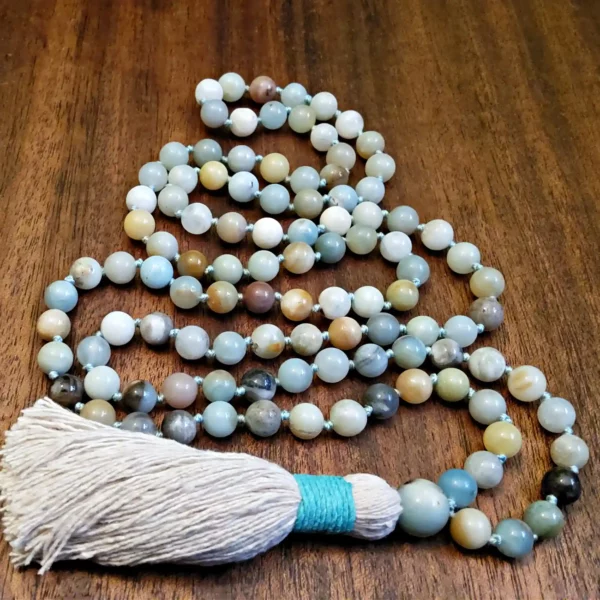 The front view of an Amazonite Mala with 108-8mm Amazonite beads, with a beige and teal tassel.