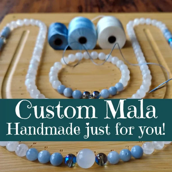 Custom mala beads on a mock-up board with a banner.